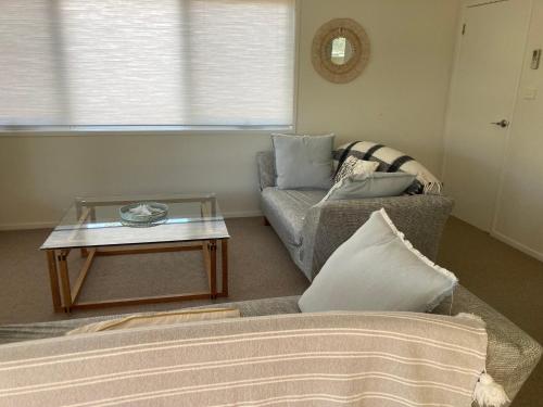a living room with a couch and a coffee table at 20 Bradley in Coles Bay