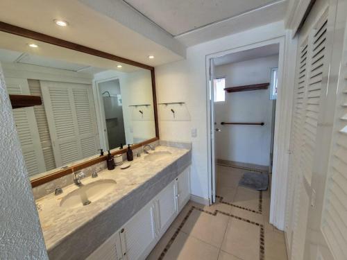 a bathroom with two sinks and a large mirror at Luxury Beachfront Condo at Iguana-Ixtapa in Ixtapa