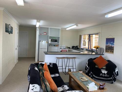 a living room with a couch and a kitchen at Seaview House Unit 2A in Whangarei