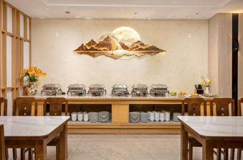 a restaurant with a counter with a stove at Cat Ba Wistaria Hotel- Jacuzzi Rooftop & Fitness in Cat Ba