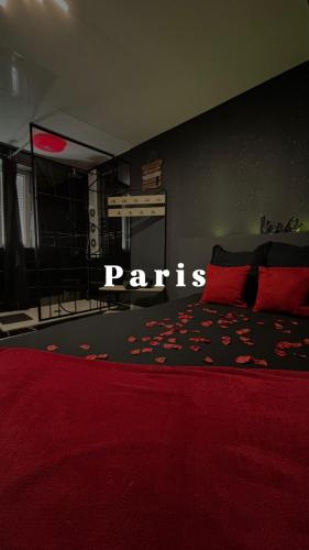 a bedroom with a red bed with a red comforter at Ô Saphir Spa - Maison N1 in Denain