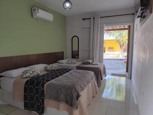 En eller flere senge i et værelse på Pousada X