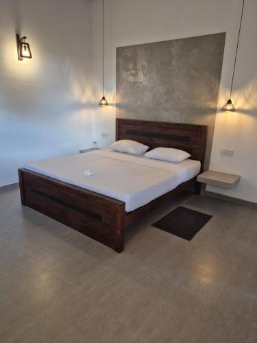 a large bed in a room with two pillows at Hiru Villa Tangalle in Tangalle