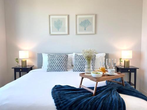 a bedroom with a large bed with a table on it at Desing district, great apartment in Miami