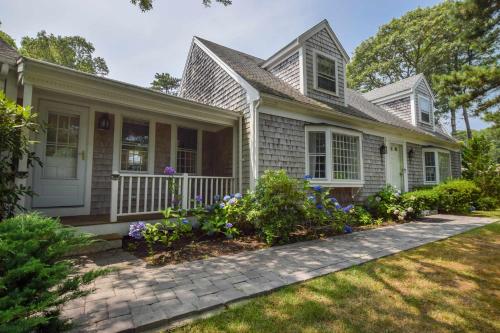 een huis met bloemen in de voortuin bij Pool Half Mile to Beach in Harwich