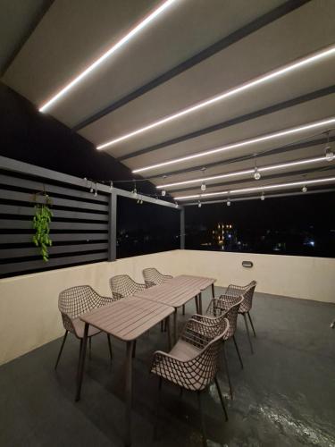 a room with a table and chairs and a balcony at So Chic Family Villa in Flic-en-Flac