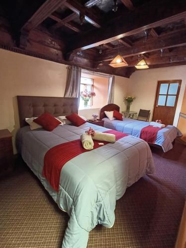 a bedroom with two beds in a room at Rumi's Inn in Cusco