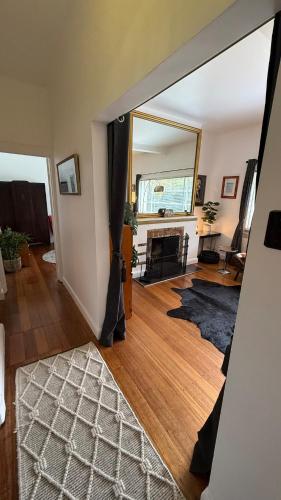 a view of a living room with a mirror at 2 bedroom Art Deco Apartment in Melbourne