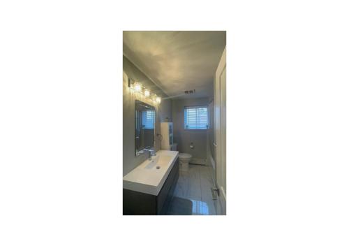 a bathroom with a sink and a mirror at Luxurious Two Bedroom Apartment in Burlington