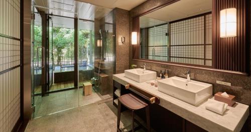 a bathroom with two sinks and a shower at Fufu Atami in Atami