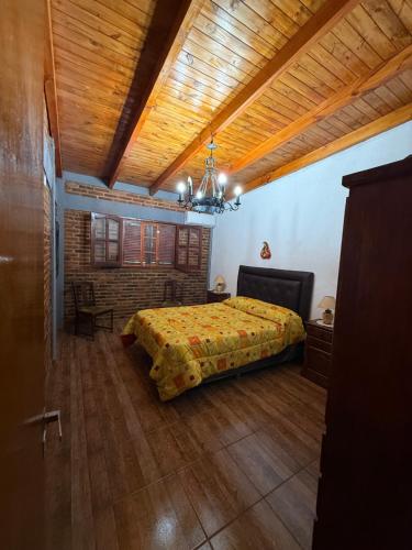 En eller flere senge i et værelse på Quincho El Aguaribay