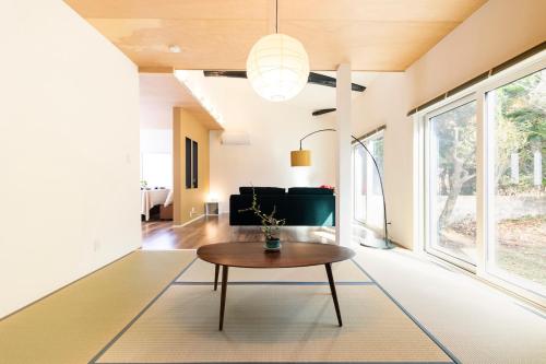 a living room with a table and a couch at 美月庵 in Kitakyushu