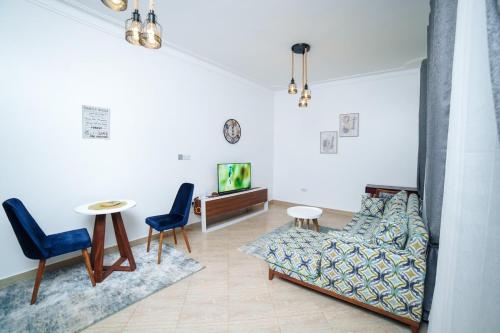 a living room with a couch and chairs and a table at Lavista Place in Jinja
