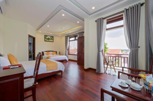 Postel nebo postele na pokoji v ubytování Paradise Boutique Hoi An