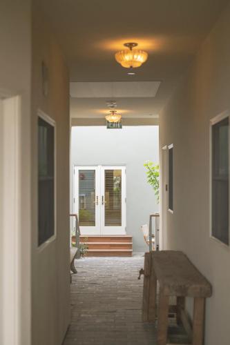 a hallway with a table and a door with a window at Gjelina Hotel in Los Angeles