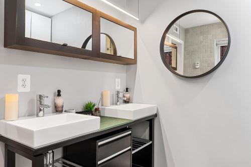 a bathroom with two sinks and a mirror at Luxe Logan Circle Escape - Near Downtown DC & Shaw in Washington
