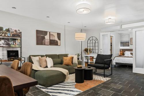 a living room with a green couch and a table at Luxe Logan Circle Escape - Near Downtown DC & Shaw in Washington