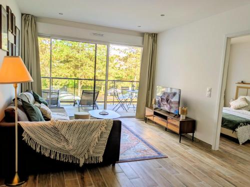 a living room with a couch and a bed at La Parent-aise in Thionville