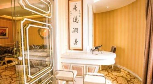 a bathroom with a sink and a mirror at Changchun Global Hotel in Changchun