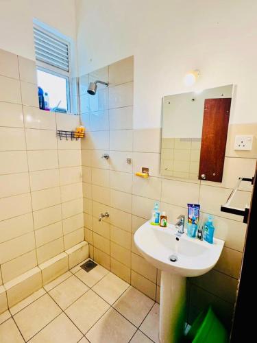 a bathroom with a sink and a shower at Homelike Apartment at Mount Clifford in Homagama