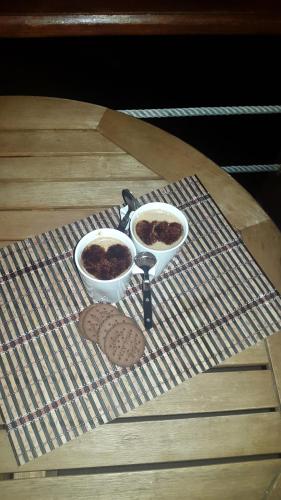 two bowls of food and cookies on a table at Adega dos Terceira in Baía de Canas