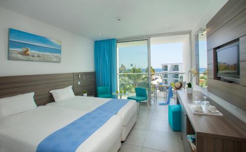Postel nebo postele na pokoji v ubytování Limanaki Beach Hotel & Suites