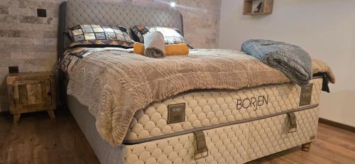 a bed in a bedroom with a large bed frame at Amore Grande in Samokov