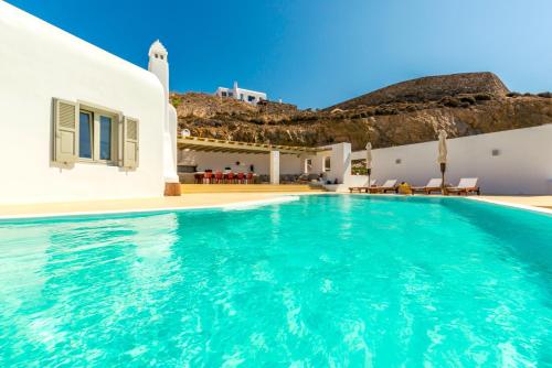 a villa with a swimming pool next to a house at Villa Ftelia Boheme in Elia