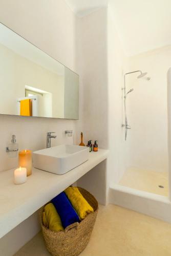 a white bathroom with a sink and a tub at Villa Ftelia Boheme in Elia