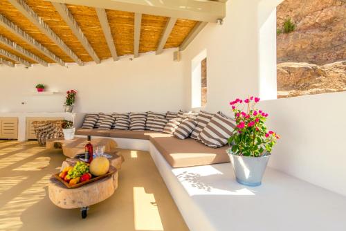 a living room with a couch and a table with fruit at Villa Ftelia Boheme in Elia