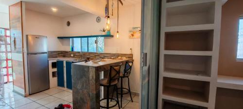 a kitchen with a counter and a refrigerator at Departamento tipo mediterraneo in Hermosillo