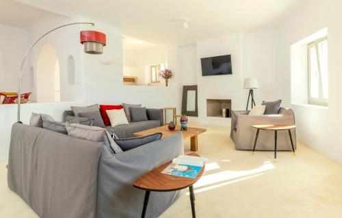 a living room with two couches and a table at Villa Ftelia Boheme in Elia