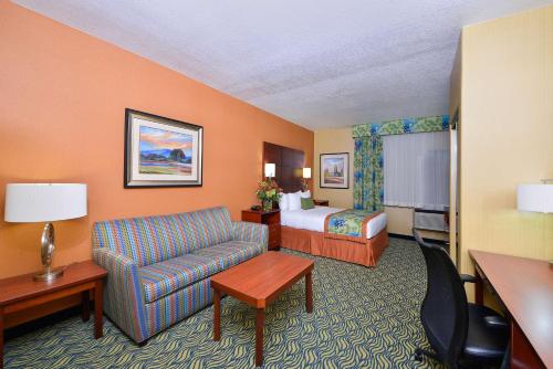 a hotel room with a couch and a bed at Best Western PLUS Fresno Inn in Fresno