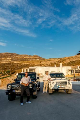 two men are standing next to their cars at Villa Ftelia Boheme in Elia