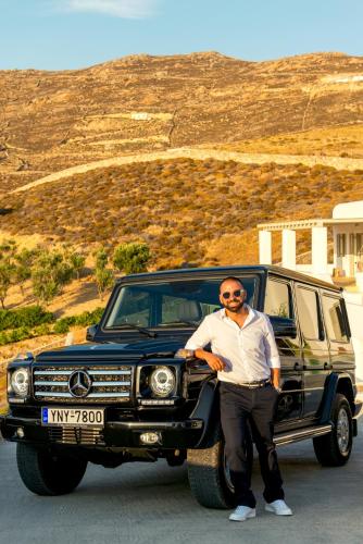 a man is standing in front of a truck at Villa Ftelia Boheme in Elia