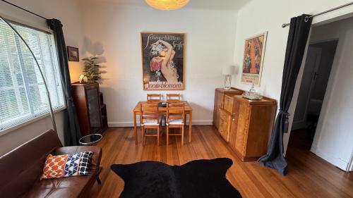 a living room with a table and a couch at 2 bedroom Art Deco Apartment in Melbourne