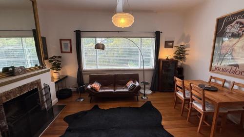 a living room with a couch and a table at 2 bedroom Art Deco Apartment in Melbourne
