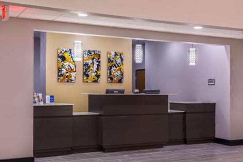 a waiting room with two paintings on the wall at Best Western Plus Regency Park in Walker