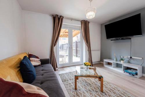 a living room with a couch and a tv at Entire 2-bed house in Stoke-on-trent in Stoke on Trent