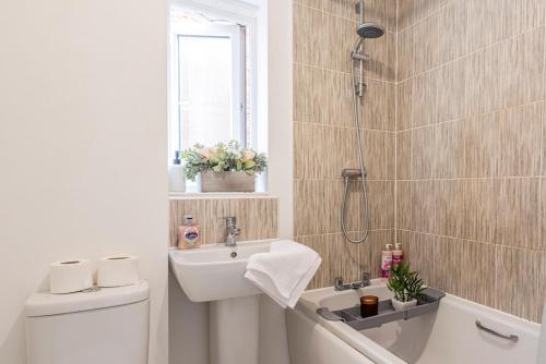 a bathroom with a shower and a sink and a toilet at Entire 2-bed house in Stoke-on-trent in Stoke on Trent