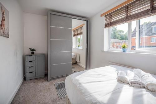 a bedroom with a bed and a walk in closet at Entire 2-bed house in Stoke-on-trent in Stoke on Trent