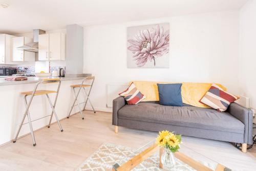 a living room with a couch and a kitchen at Entire 2-bed house in Stoke-on-trent in Stoke on Trent