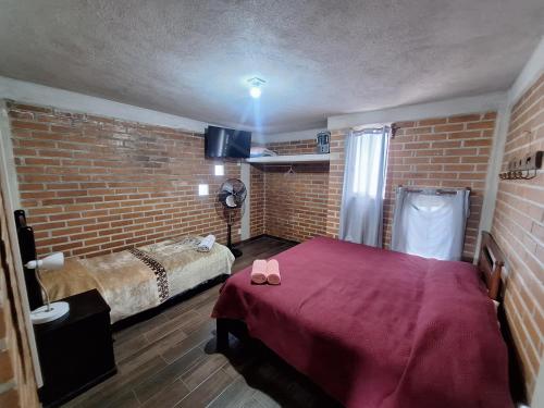 a bedroom with a bed and a brick wall at 3- Departamento con terraza in Amecameca de Juárez