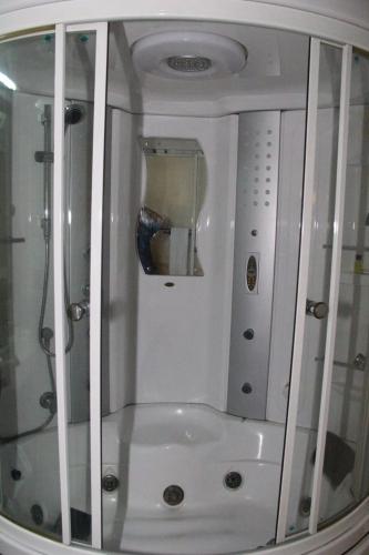 a bathroom with a shower and a sink in a room at Alsafina hotel in Lahore