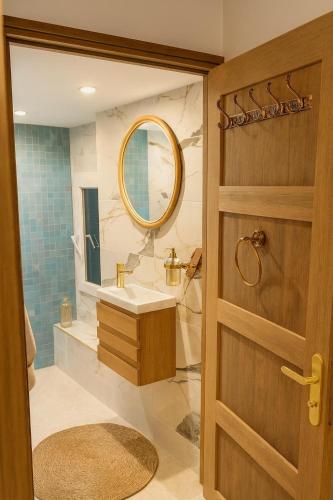 a bathroom with a sink and a mirror at Villa De Alexiano in Alixan