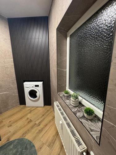 a bathroom with a washing machine and a washer at Apartment Almtal Liebe in Viechtwang