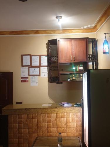a kitchen with a refrigerator and a microwave at KBK Comfort Accommodation in Kampala