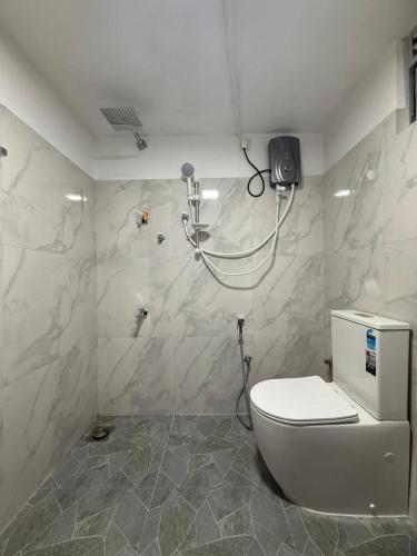 a bathroom with a toilet and a shower at White place in Ahangama
