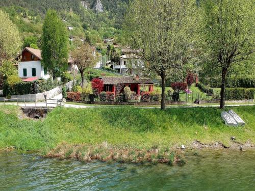 a house on the side of a river at Idyllic cottage next to the beautiful Lake Idro in Crone