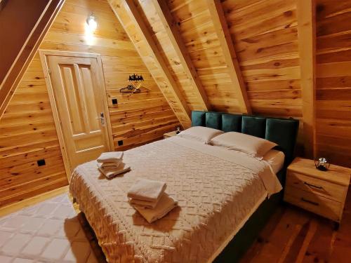 a bedroom with a bed in a wooden cabin at Durmitor sky in Žabljak